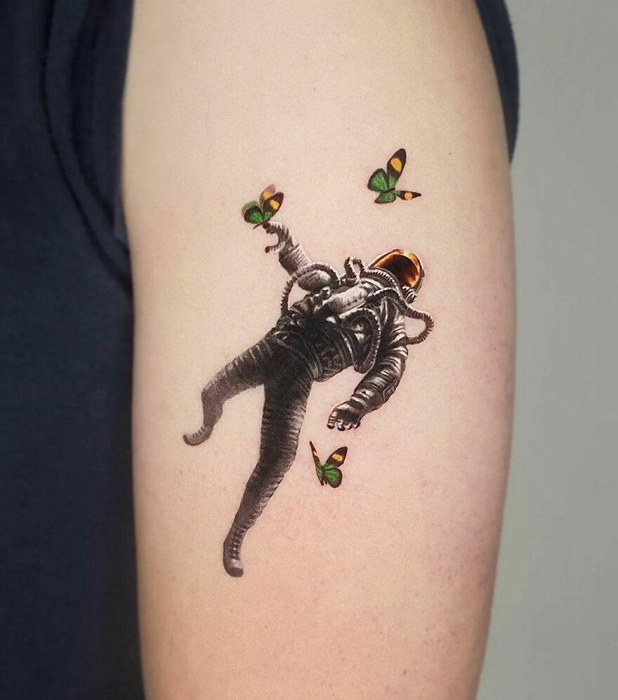 Astronaut with butterflies arm tattoo
