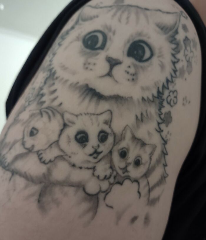 Cat-themed tattoo featuring a large cat and three smaller cats with floral accents.