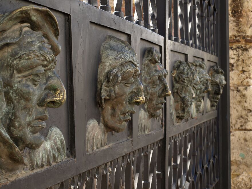 Metal Cast Faces In A Side Gate To Catedral De Santa Maria La Menor