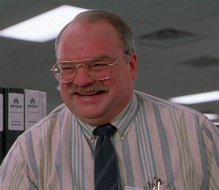 Richard Riehle looking and laughing in movie Office Space