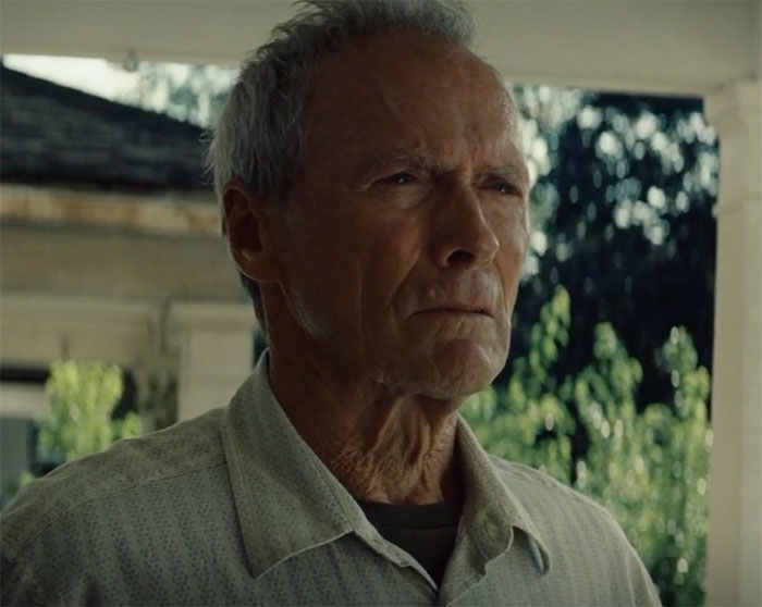 Clint Eastwood standing and looking in movie