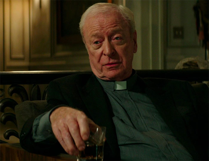 Michael Caine sitting and drinking in movie The Last Witch Hunter