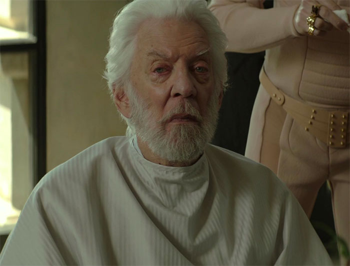 Donald Sutherland sitting and looking in movie Hunger Game