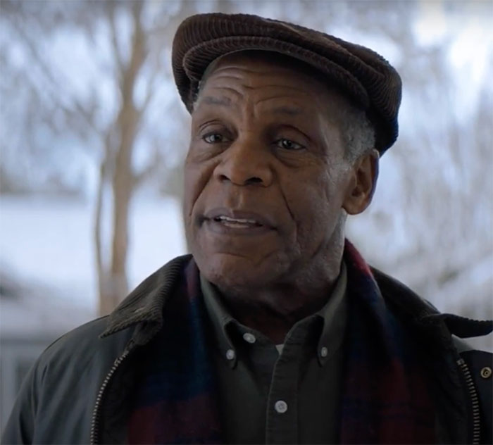 Danny Glover wearing hat standing and talking in the movie