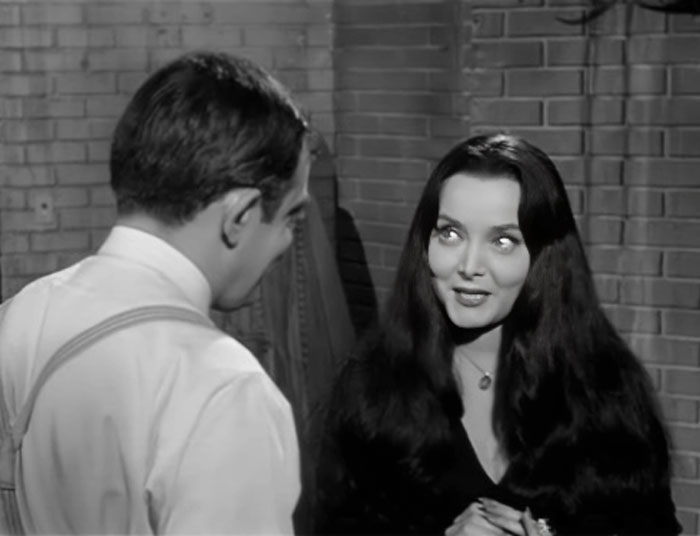 Morticia and Gomez are talking with each other
