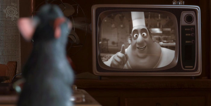 Cartoon character watching a TV chef in a black-and-white scene.