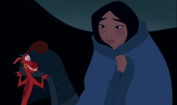 Mulan covered with a blanket and Mushu smiling and looking at her 
