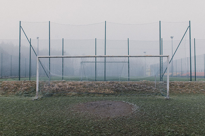 Football goal net on the frosty grass
