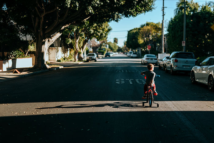 Child riding bicycle on road