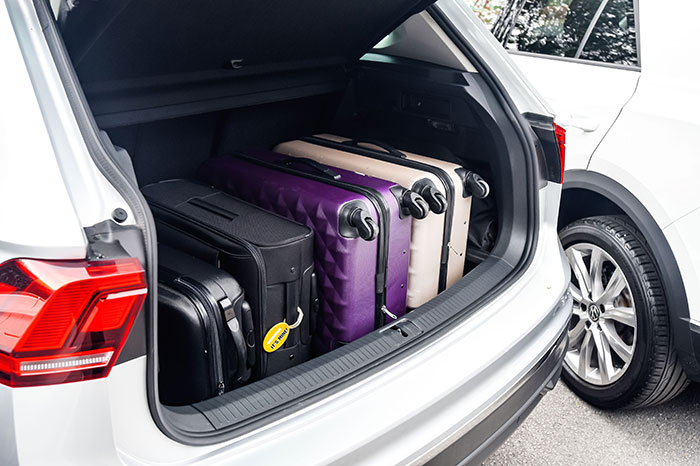 A car with a suitcase in the trunk