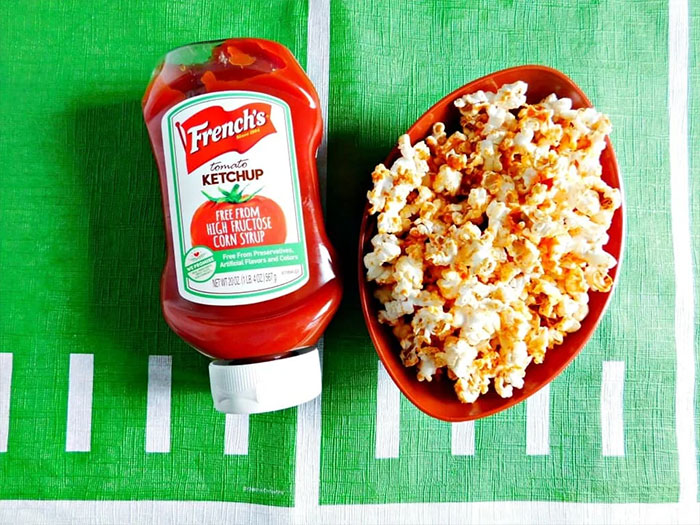 Bowl of popcorn and ketchup boottle