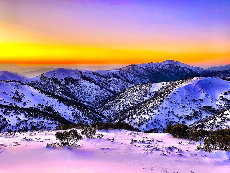 A multitude of colours fill the sky over Mount Feathertop as seen from Mount Hotham in the Alpine National Park
