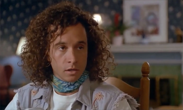 Pauly Shore looking and talking to someone 