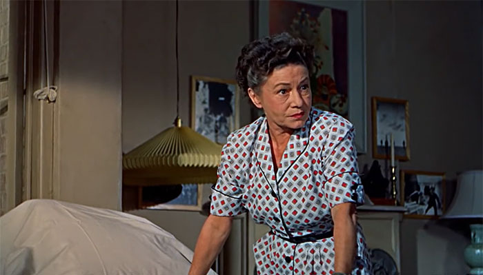 Thelma Ritter leaning on a bed 