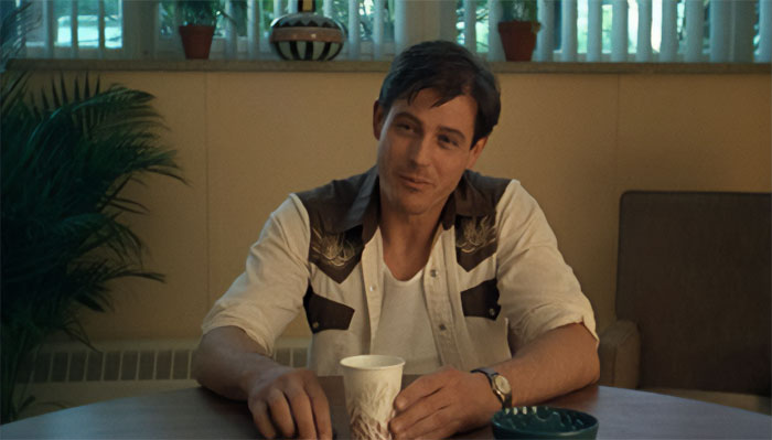 Michael Paré looking at someone with a smile 