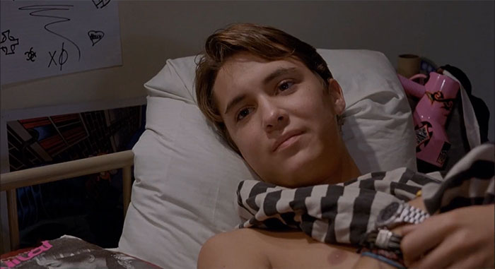 Wil Wheaton laying in bed and looking at someone 