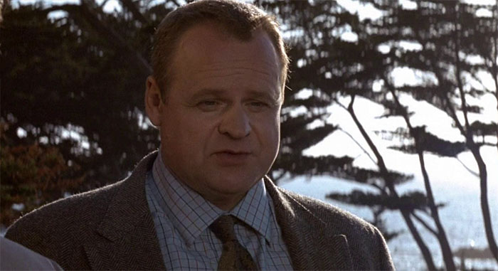 George Dzundza looking down 