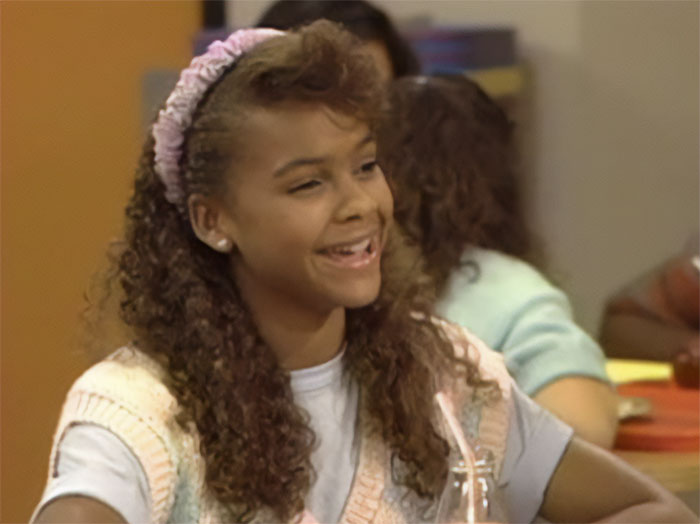 Lark Voorhies looking at someone and laughing 