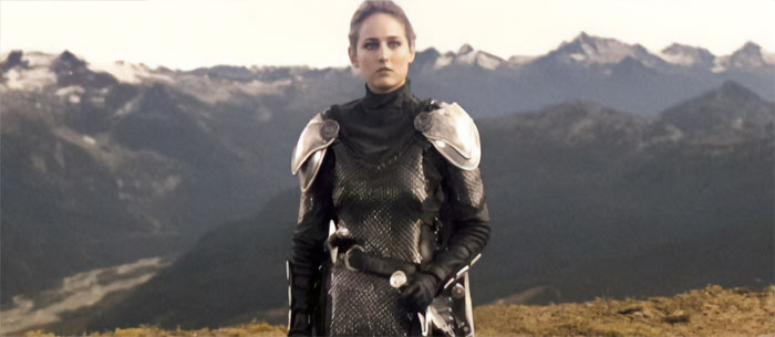 Leelee Sobieski standing on a mountain with armor 