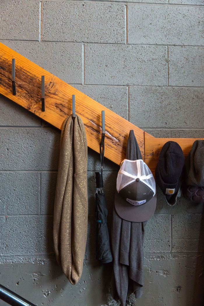 Coat rack with hats, scarves, and an umbrella showcasing home organization ideas.