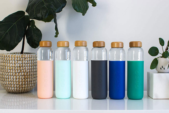 Six stylish reusable bottles on a shelf, showcasing home organization ideas.