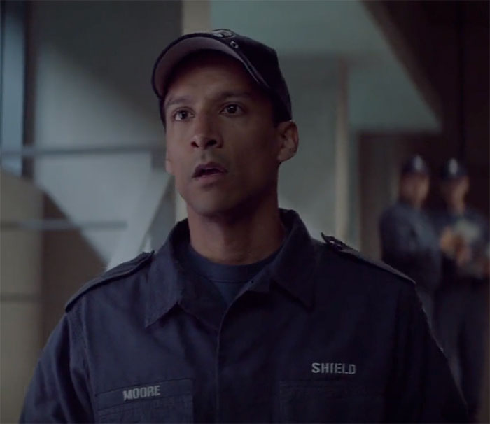 Danny Pudi standing and looking in movie Captain America: the Winter Soldier