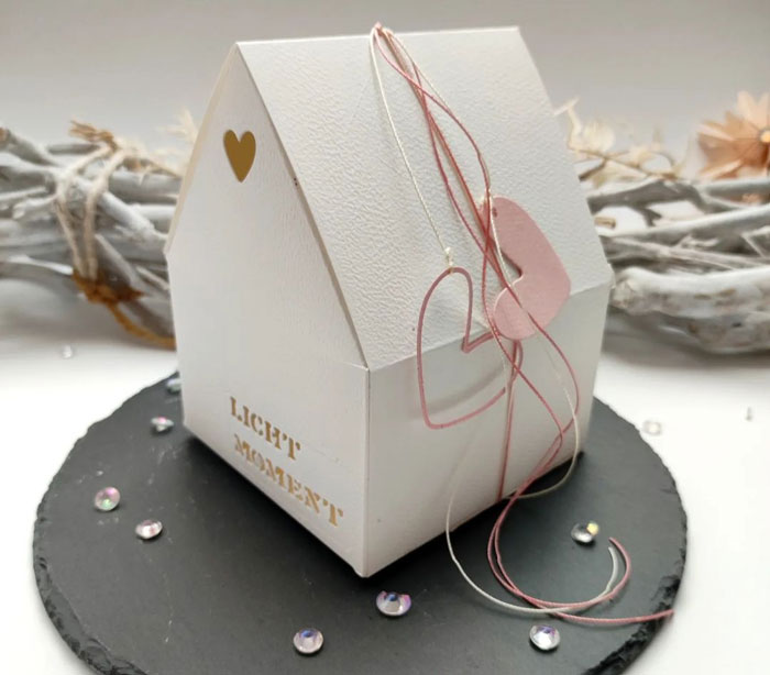 a white paper house made out of a paper