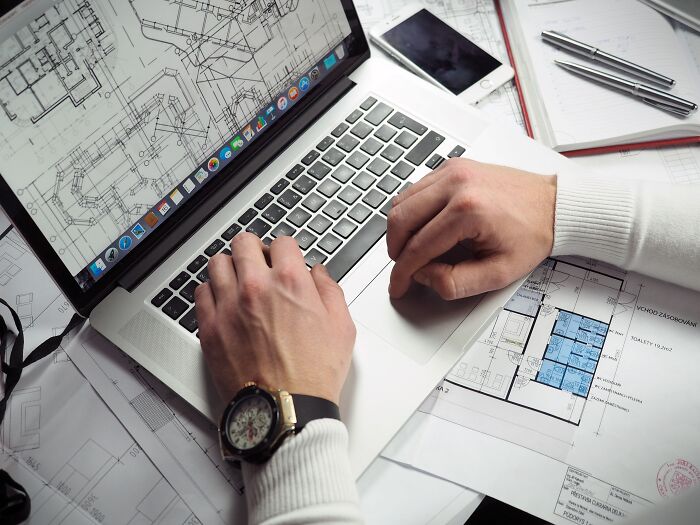 Person making a house plan on the laptop 
