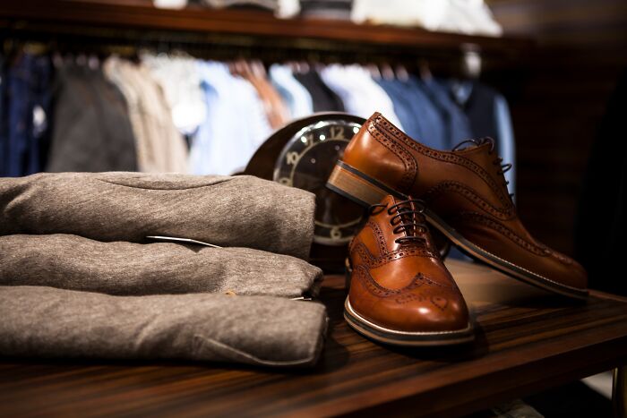 Picture of brown shoes and clothes on the table