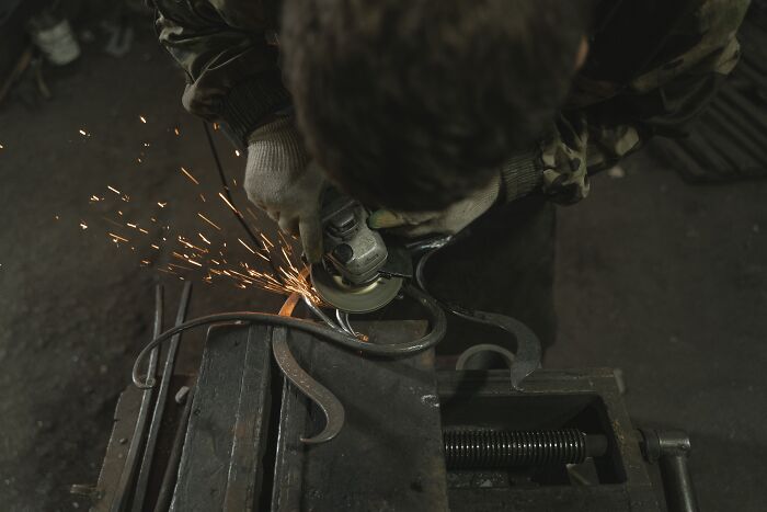 blacksmith cuts metal 