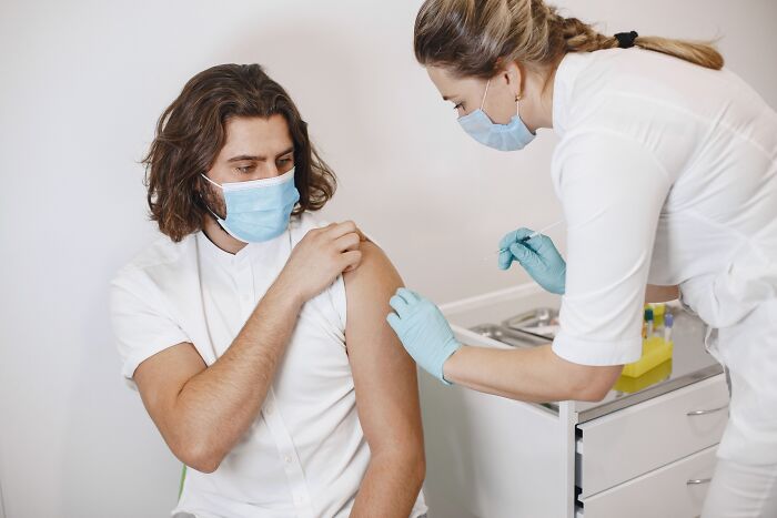 Woman vaccinating person