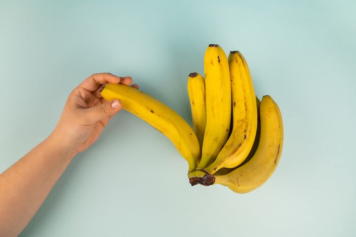 Person holding a banana 