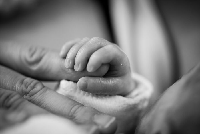 Newborn Holding Her Mom's Finger 
