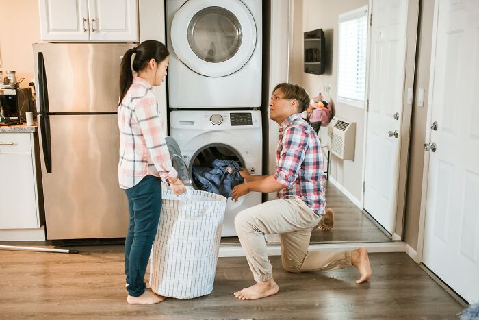 Couple Holding Laundry Basket 