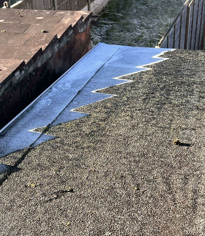The Shadow Of My Neighbors' Roof Leaving This Pattern Of Ice On Mine