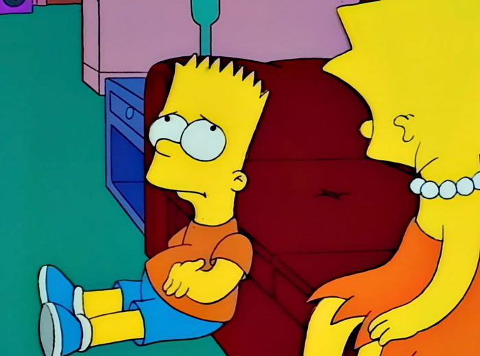 Bart is upset sitting near the couch 