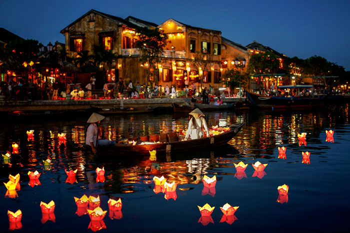 River filled with handmade lanterns in a city 