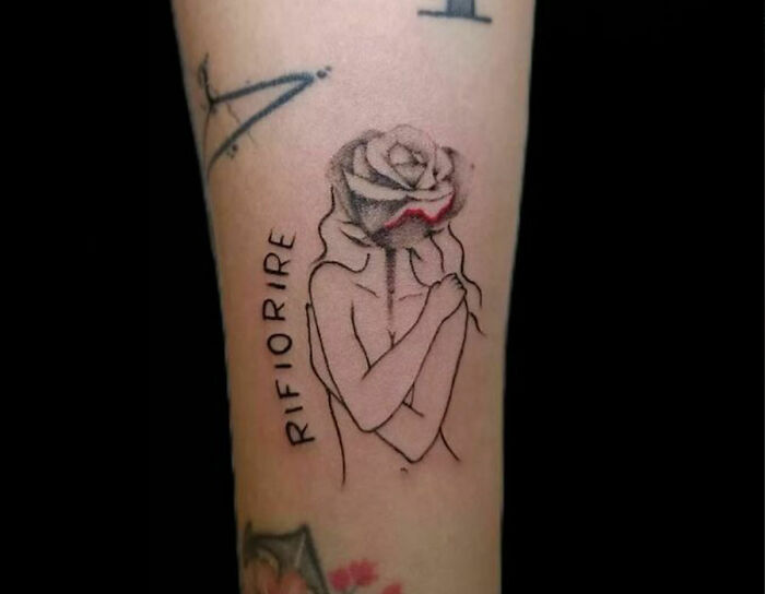 Woman with rose head arm tattoo