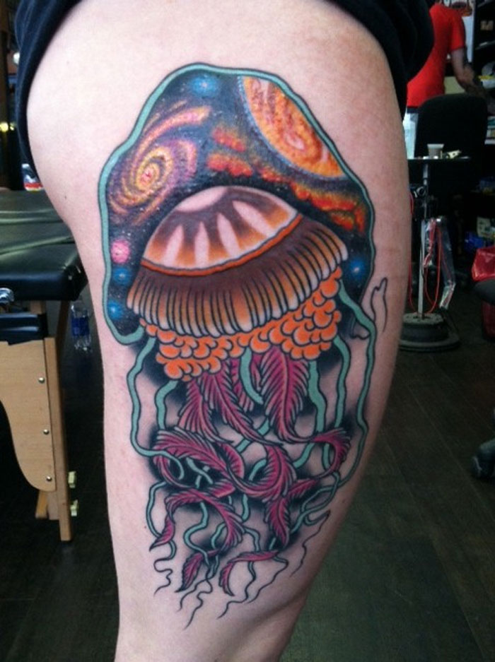 Space jellyfish thigh tattoo