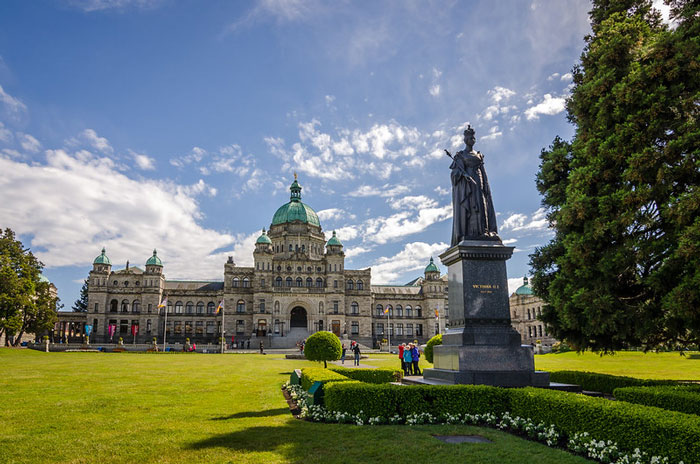 British Columbia parliament building with Queen Victoria in front of it