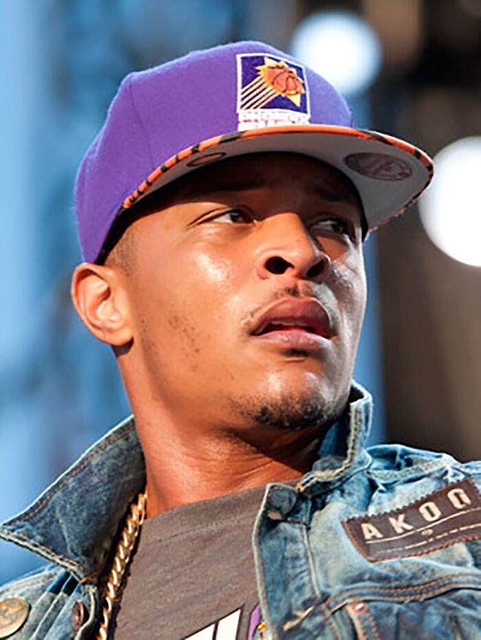 Celebrity wearing a purple cap and denim jacket, related to jail and crime.