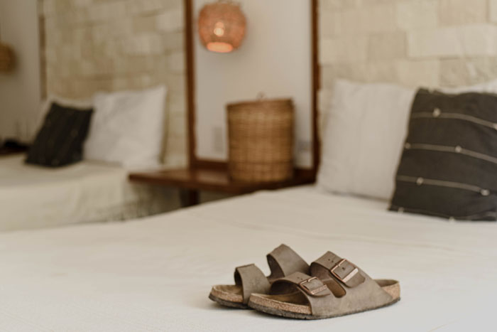 Birkenstocks placed on a bed
