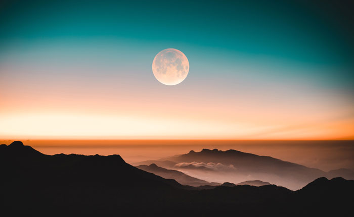 Moon in the sky above mountains