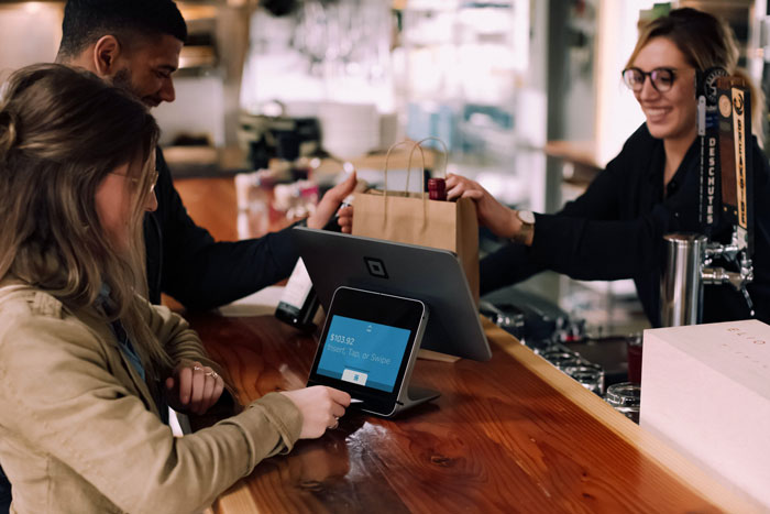 A couple buying wine at cashier