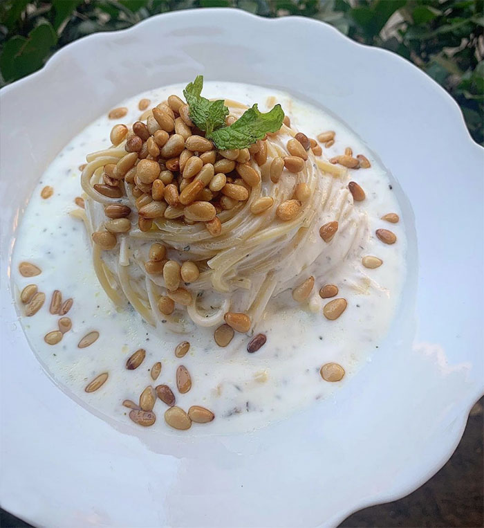 Plate of spaghetti with nuts and yogurt sauce