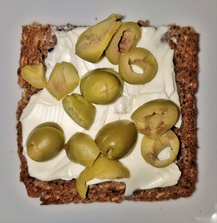 Sandwich with cream cheese and green olives