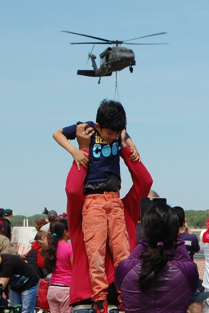 At An Air Show Today, I Accidentally Caught What Looks Like A Tiny Black Hawk Stealing A Child