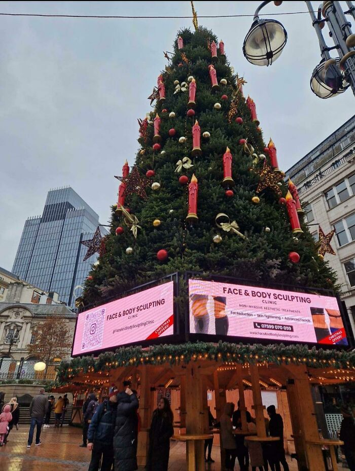 Plastering Ads On A Giant Christmas Tree At A Christmas Market