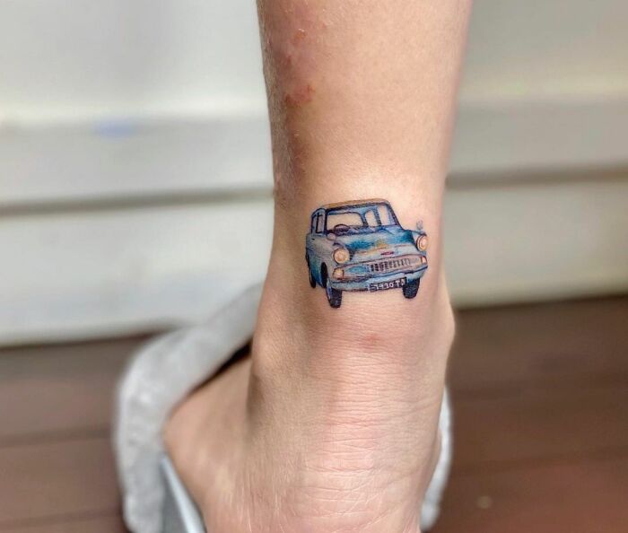 Harry Potter tattoo of a blue flying car on ankle, showcasing detailed art for dedicated fans.