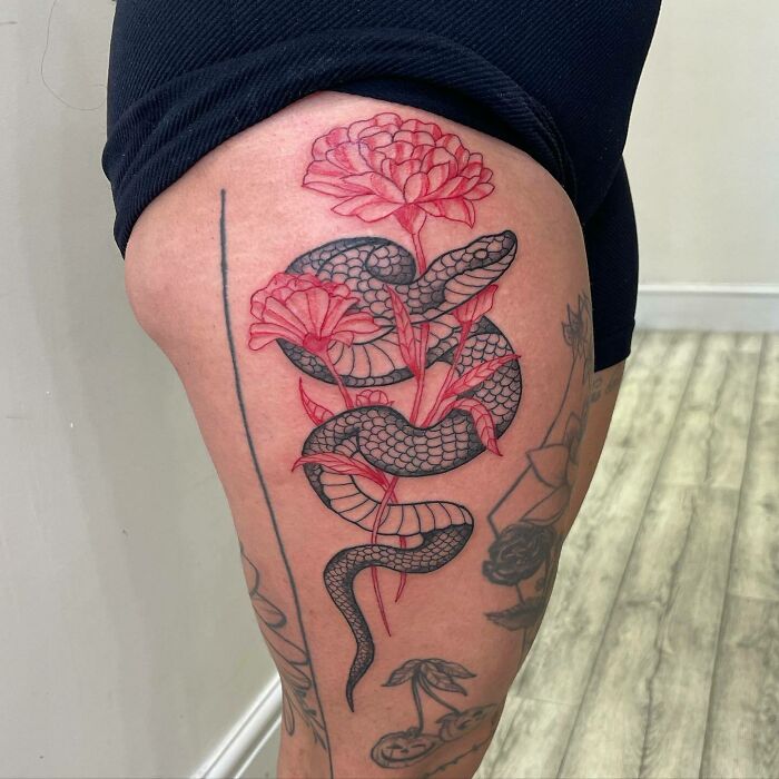 Black snake and red flower leg tattoo 